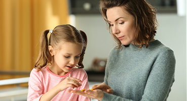 Mother looking at compounded medication with daughter